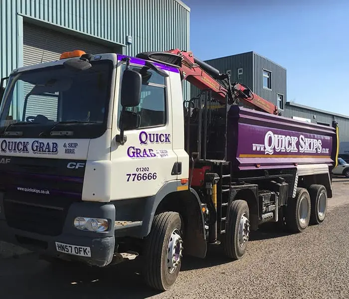 Quick Skips grab hire lorry loading waste on site in Christchurch, Dorset
